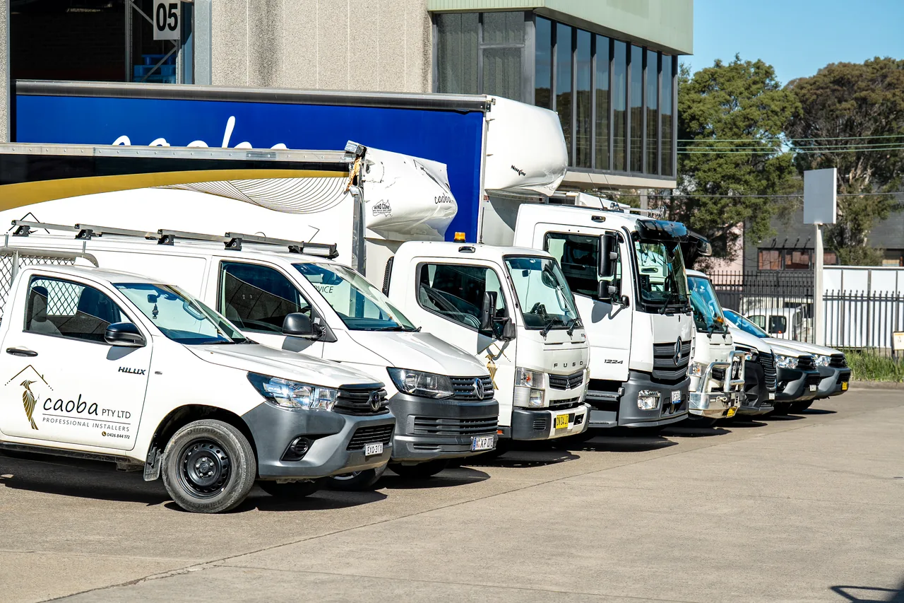 Caoba-branded ute, vans and trucks parked at the warehouse